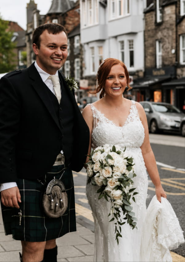 Newly married couple with bespoke Moody Cows wedding flowers