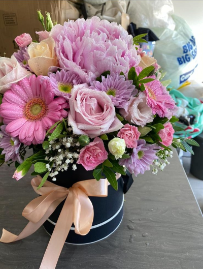 Pink Perfection - A gorgeous hatbox arrangement in soft pink and lilac shades, finished with an elegant bow.